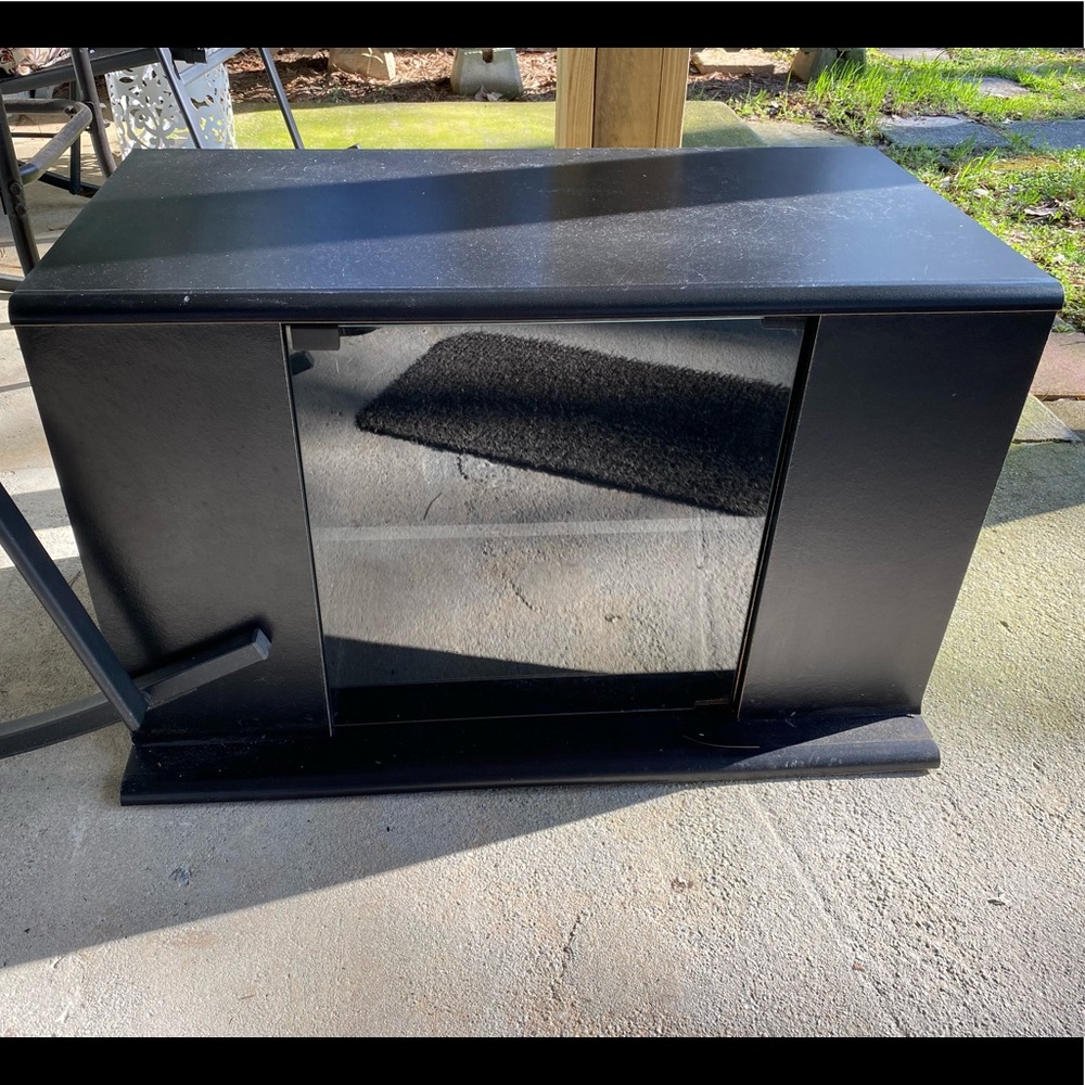 Black television stand with glass door